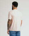 Man wearing Coral Blush Classic Crew Neck T-shirt with tattooed arm.