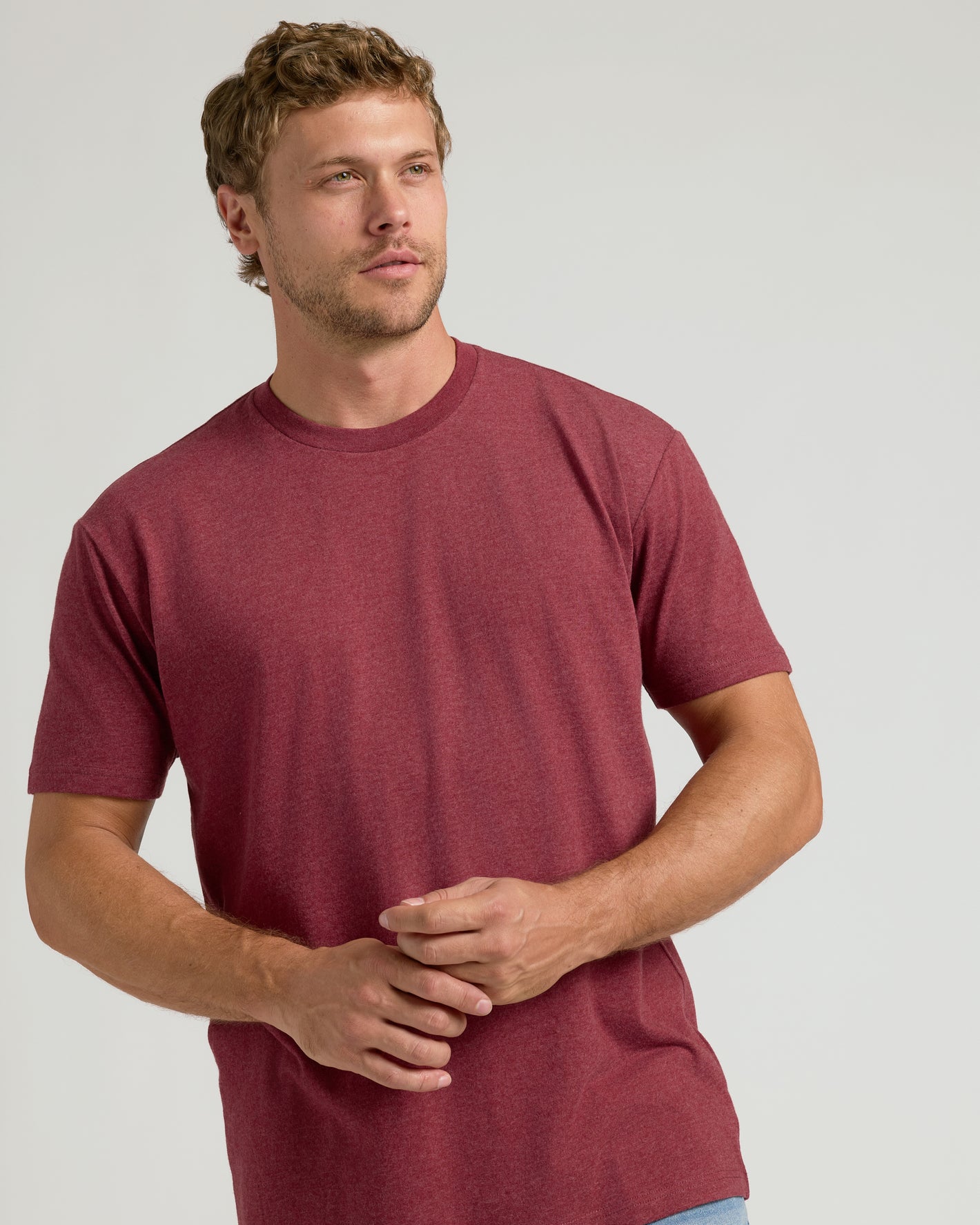 Dark Heather Claret Classic Crew Neck on young man, neutral backdrop.