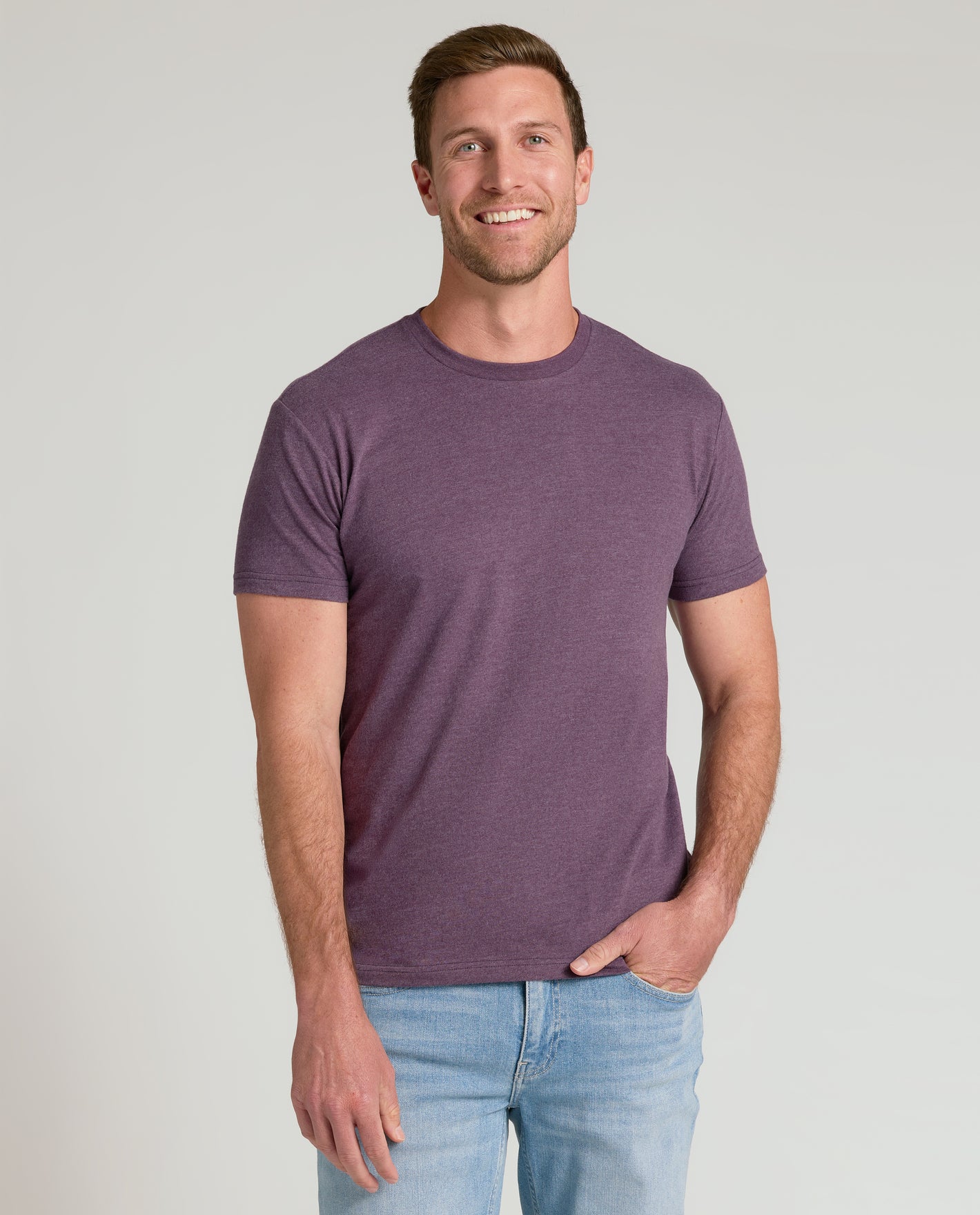 Man in Seasonal Classic Crew Neck T-shirt and jeans smiling.