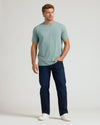 Man in Heather Balsam Classic Crew Neck, jeans, sneakers.