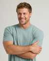 Man wearing CombinedListingTest Classic Crew Neck, arms folded, smiling.