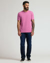 Man wearing Heather Magenta Classic Crew Neck, dark jeans, black sneakers.