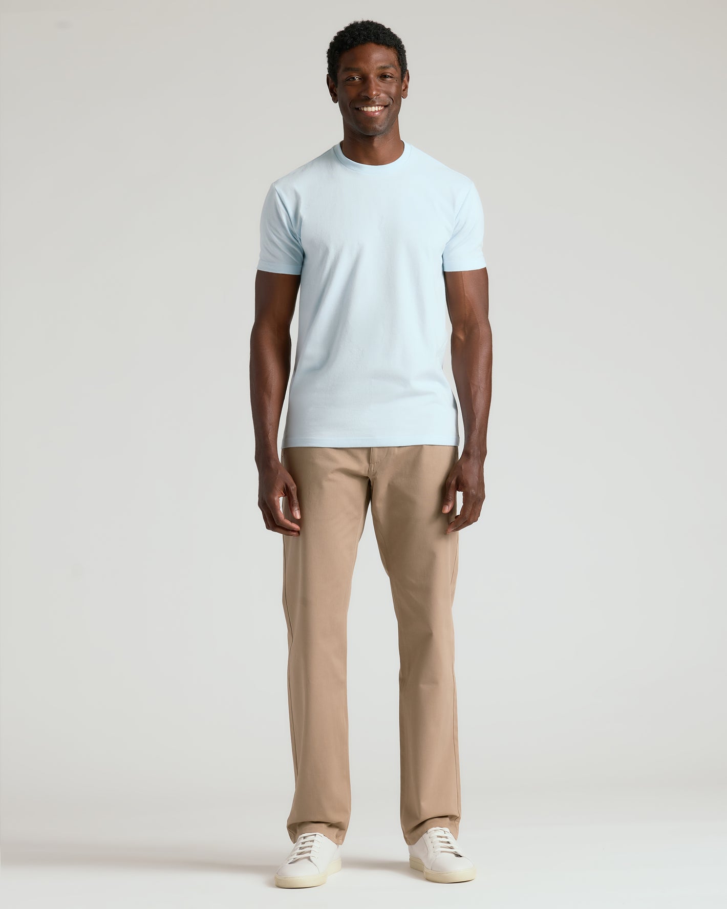 Man wearing Icicle Classic Crew Neck, khaki pants, and white sneakers.