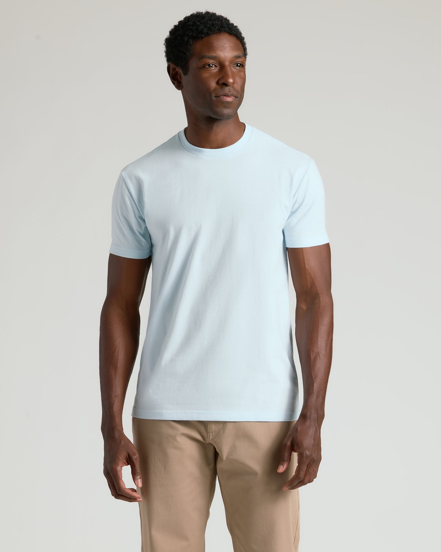 Man wearing Icicle Classic Crew Neck T-shirt and khaki pants.