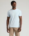 Model in Classic Crew Neck 3-Pack t-shirt and beige trousers.