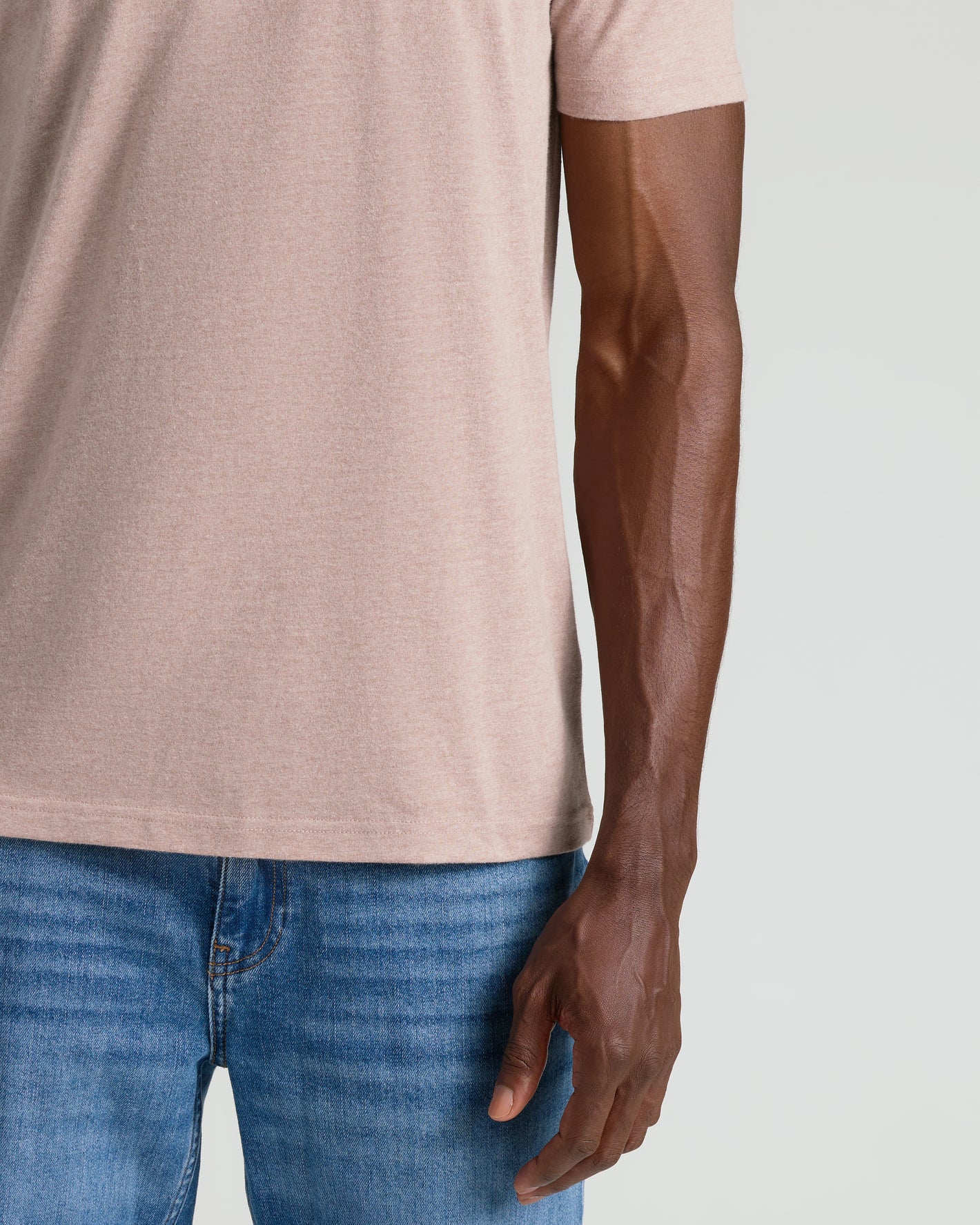 Light Heather Slate Mauve Classic Crew Neck tucked into blue jeans.