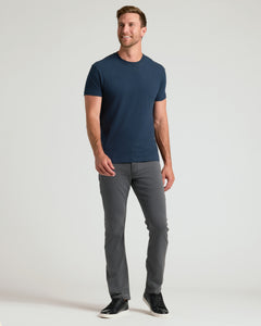 True ClassicMan in navy Classic Crew 10-Pack T-shirt, gray jeans, black sneakers.