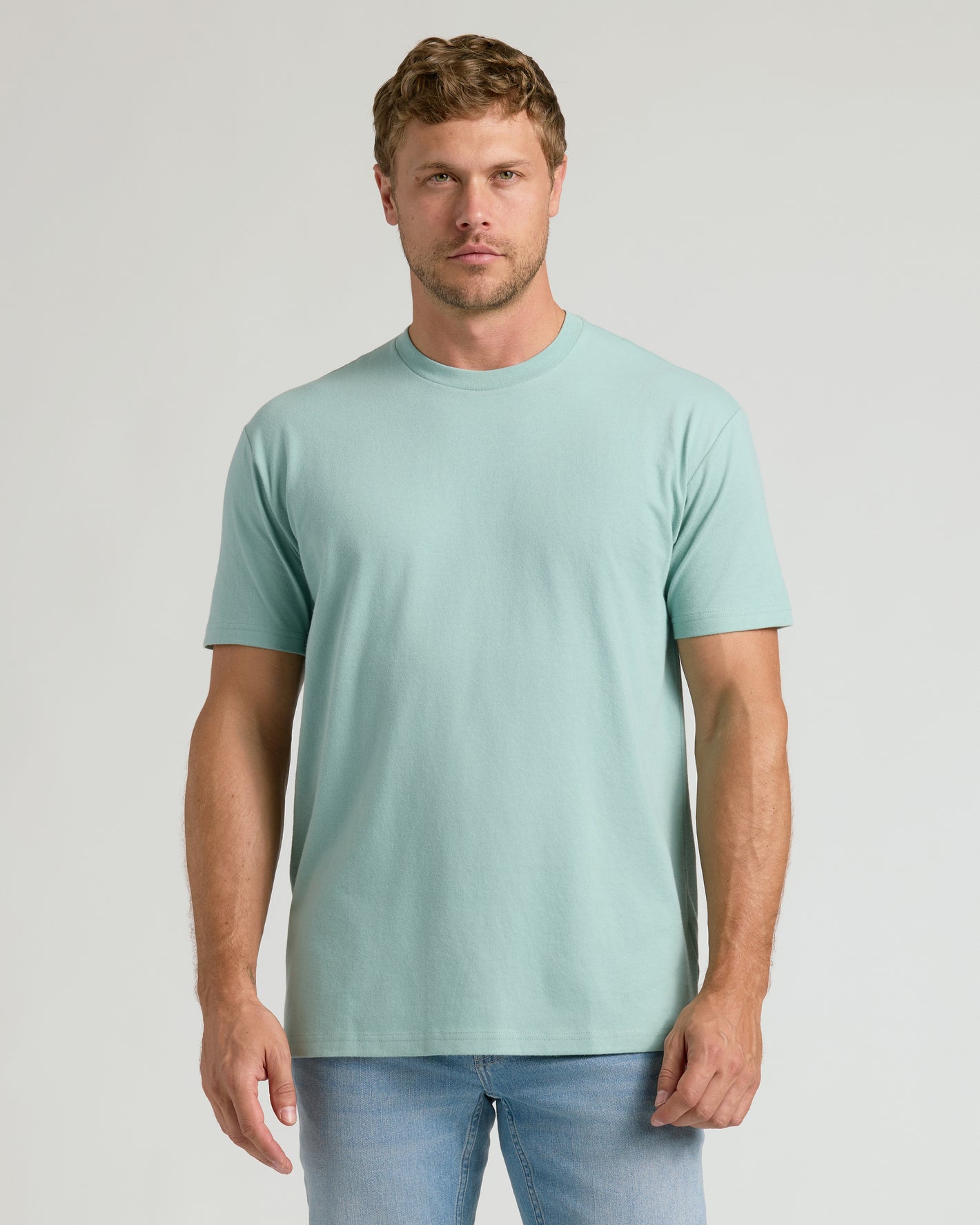 Man wearing Seabreeze Classic Crew Neck T-shirt with light-wash jeans.