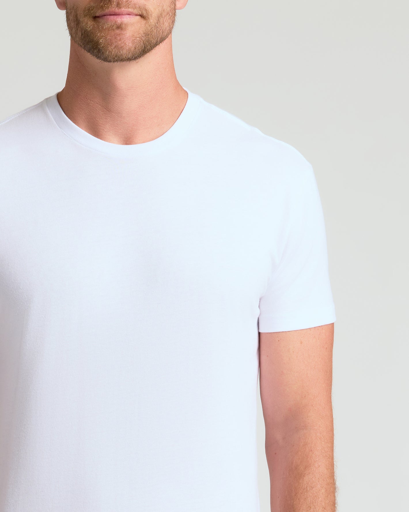 Man wearing Classic Crew 4-Pack, white fitted crew-neck T-shirt.