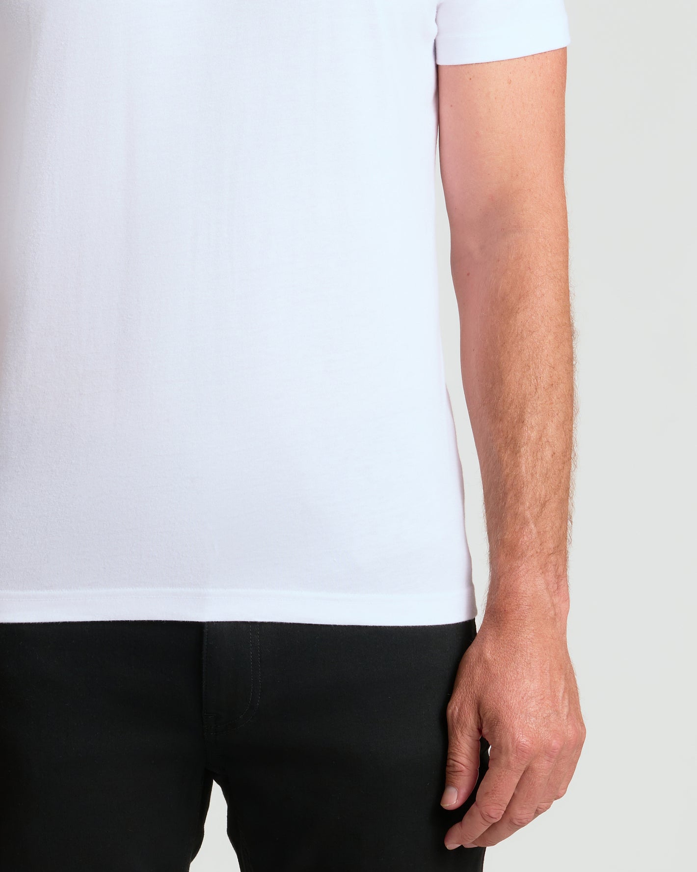 Person in Classic Crew 4-Pack white T-shirt, black pants visible.