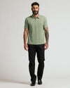 Man wearing Dark Heather Bay Green Classic Polo with black trousers.