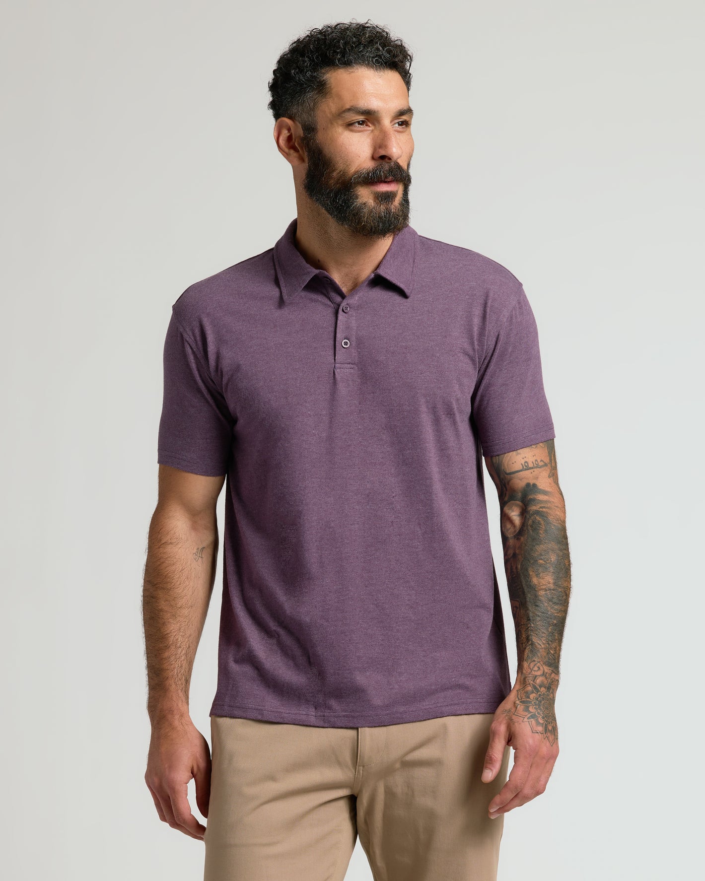 Man in Heather Polo 3-Pack, purple shirt, khaki pants.
