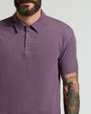 Man in Dark Heather Plum Classic Polo with tattooed arm.