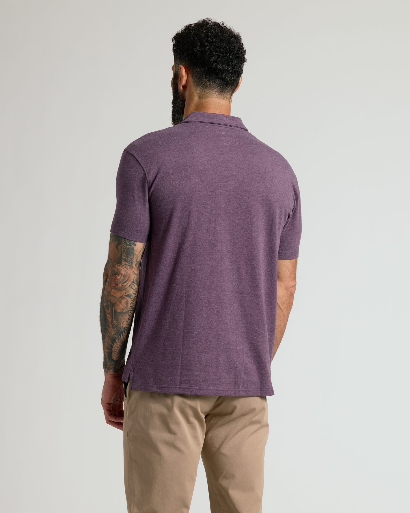 Back view of man in Dark Heather Plum Classic Polo.
