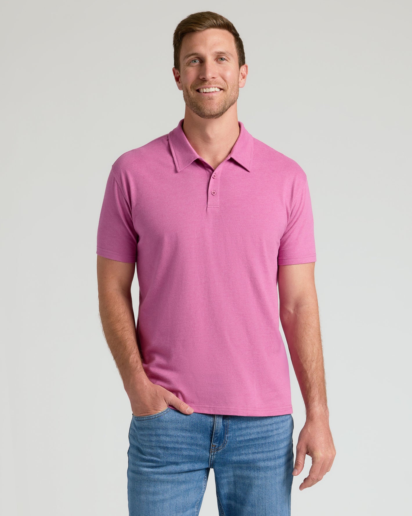Man wearing Heather Magenta Classic Polo with blue jeans.