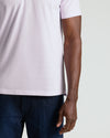 Heather Orchid Classic Polo worn with dark jeans, highlighting its fitted design.