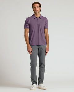 True ClassicMan wearing a purple polo shirt and gray pants on a white background