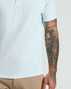 Icicle Classic Polo with tattooed arm detail.