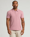 Man in Seasonal Classic Polo, heathered rose-pink, with tattoos, smart-casual look.