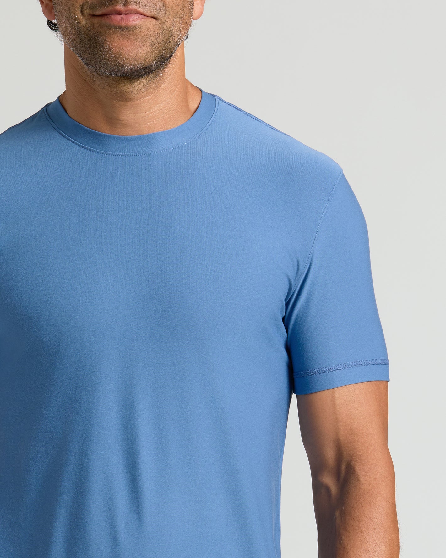Man wearing Azul Active Crew Neck Tee in light-blue, showcasing its fit.