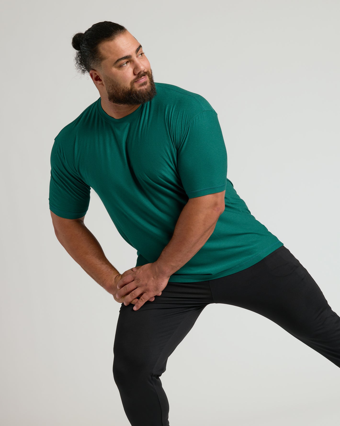 Man stretching in Clover Active Crew Neck Tee.