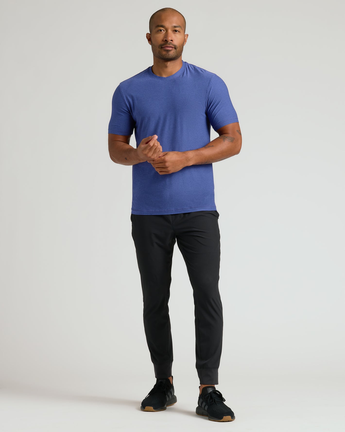 Man wearing Cosmos Active Crew Neck Tee with joggers and sneakers.