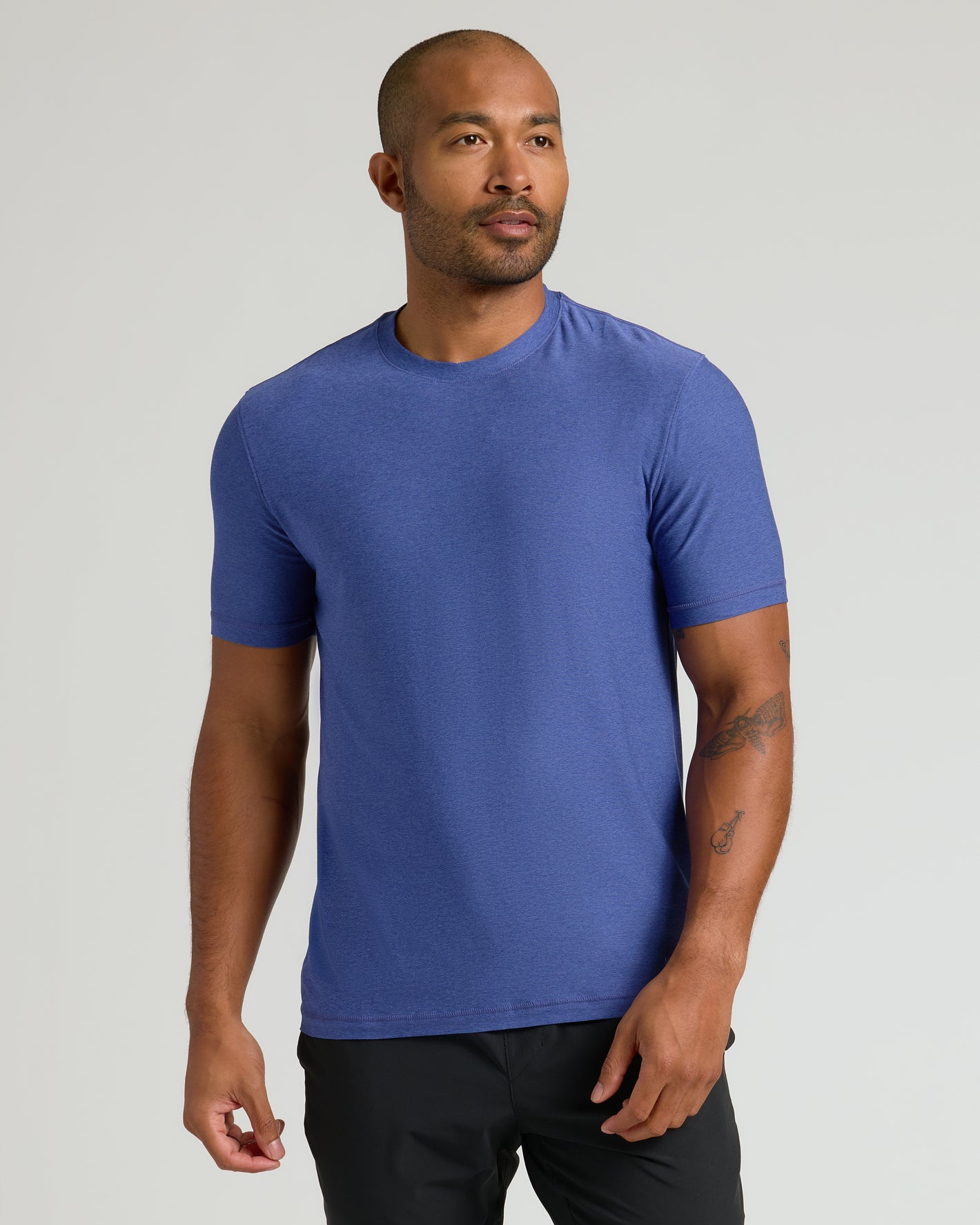 Model wearing Limited Spring Active Crew in royal-blue, showcasing tattoos.