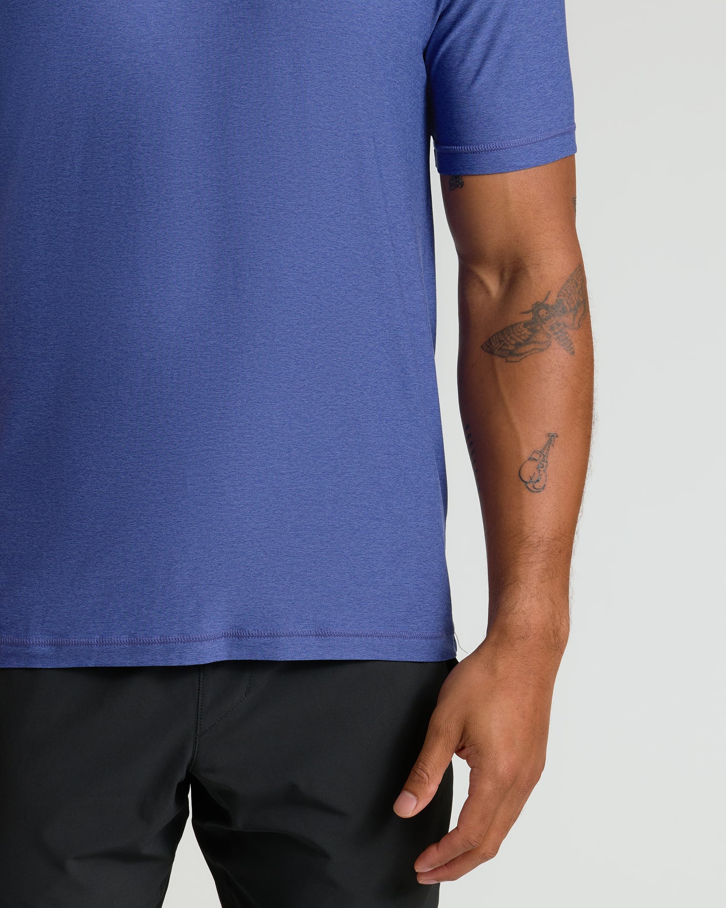 Cosmos Active Crew Neck Tee on man with tattoos, relaxed pose.