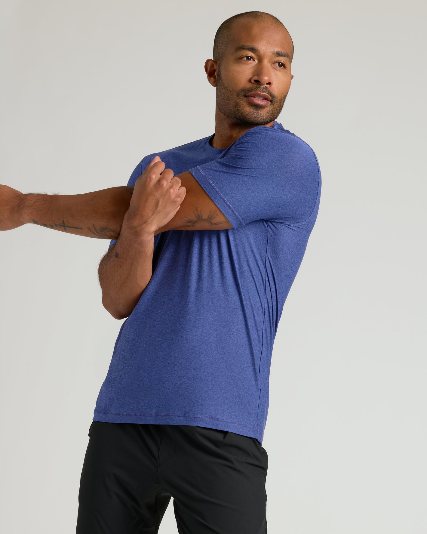 Man stretching in Cosmos Active Crew Neck Tee.