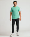 Man wearing Fern Active Crew Neck Tee, slim-fit joggers, and white sneakers.