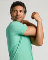 Fern Active Crew Neck Tee on man, stretching shoulder.