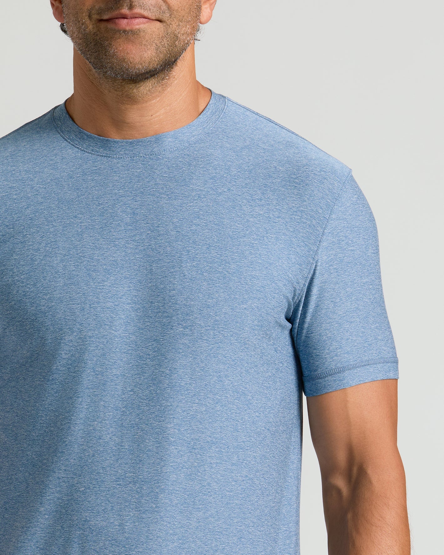 Man wearing Heather Azul Active Crew Neck Tee.