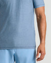 Heather Azul Active Crew Neck Tee worn mid-section view, right arm visible.