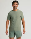 Male model wearing Heather Juniper Active Crew Neck Tee and shorts.