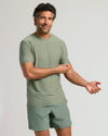 Heather Juniper Active Crew Neck Tee on man adjusting sleeve.