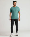 Man wearing Evergreen Active Crew Neck Tee with black joggers and running shoes.