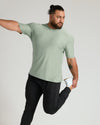 Man stretching in Lichen Active Crew Neck Tee.
