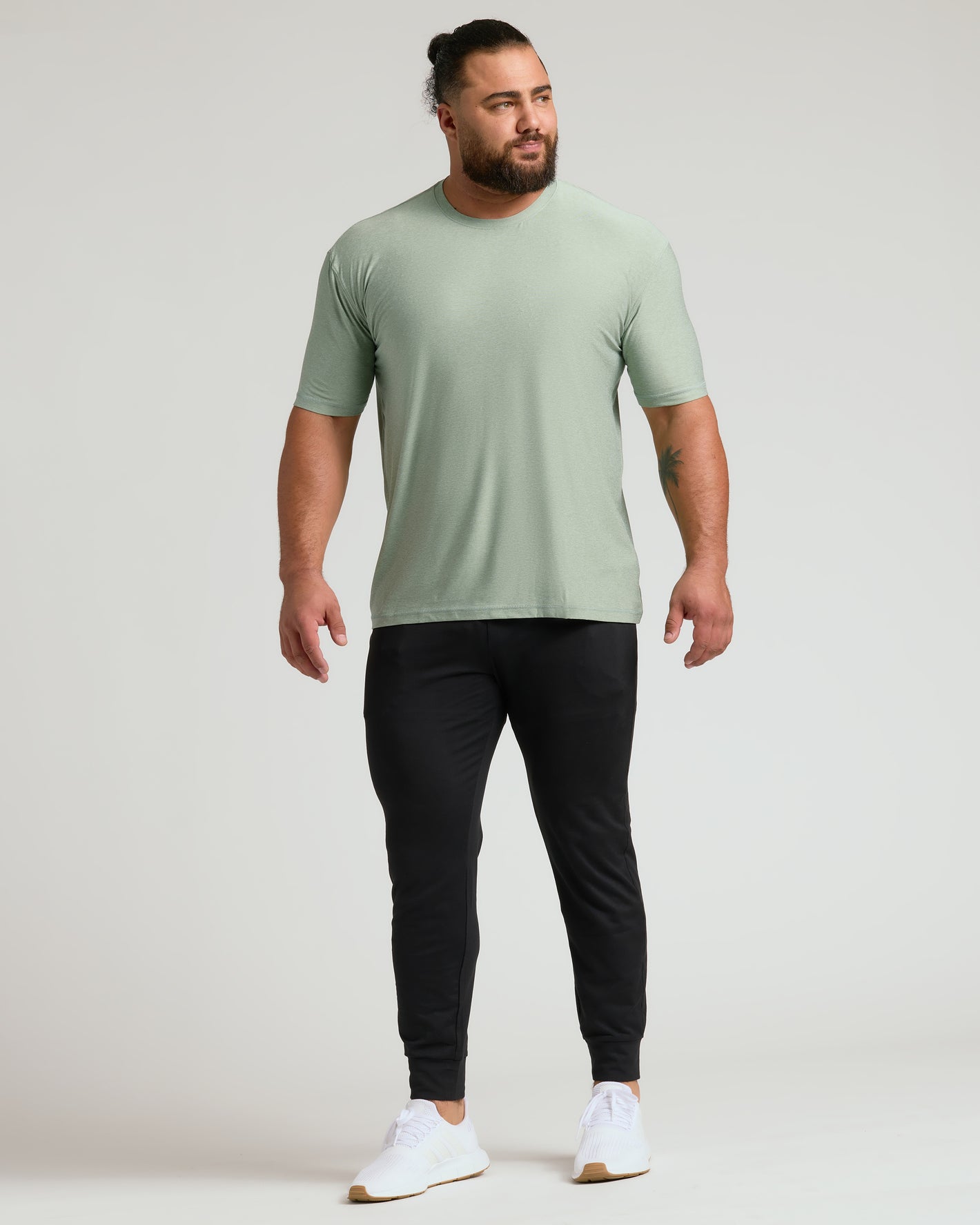 Man models Lichen Active Crew Neck Tee with joggers and sneakers.