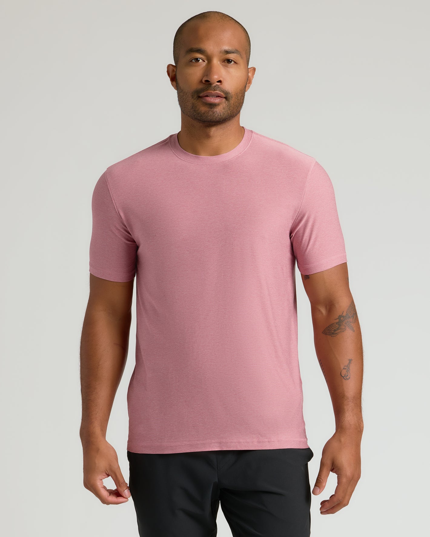 Man in muted pink Limited Spring Active Crew T-shirt, athletic pants.