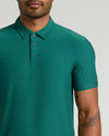 Man wearing Clover Active Polo 2.0, emerald-green, short-sleeve, three-button design.