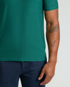 Clover Active Polo 2.0 worn with navy pants, showcasing tattoos.