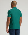 Back view of Clover Active Polo 2.0, showcasing tattoos and contemporary fit.