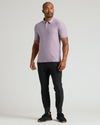 Man wearing Iris Active Polo 2.0, slim-fit pants, athletic sneakers.