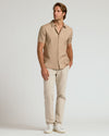 Model wearing Dusty Taupe Short Sleeve Linen Shirt with beige trousers.