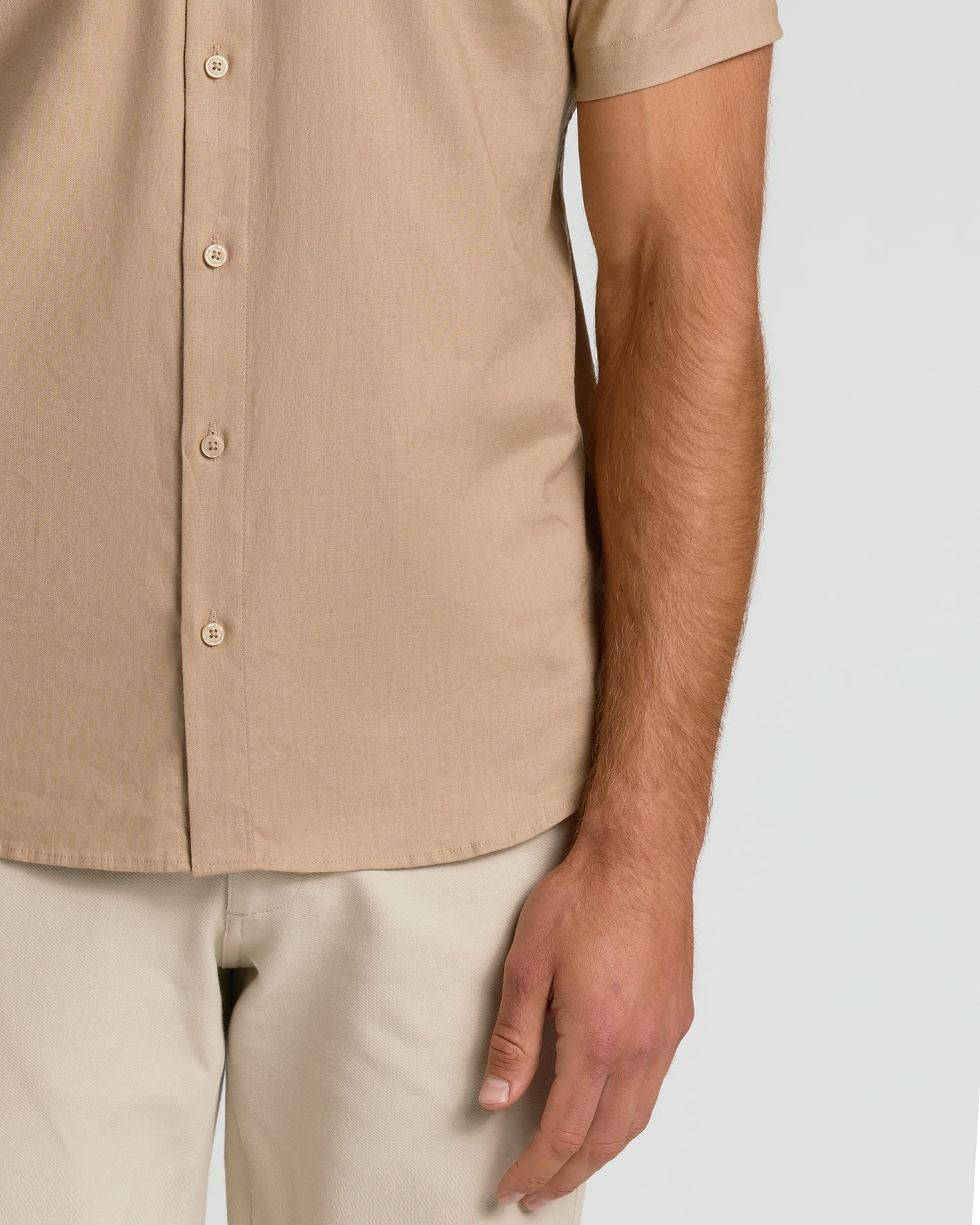 Dusty Taupe Short Sleeve Linen Shirt worn with light pants.