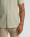 Mossy Oak Short Sleeve Linen Shirt worn untucked over khaki pants.