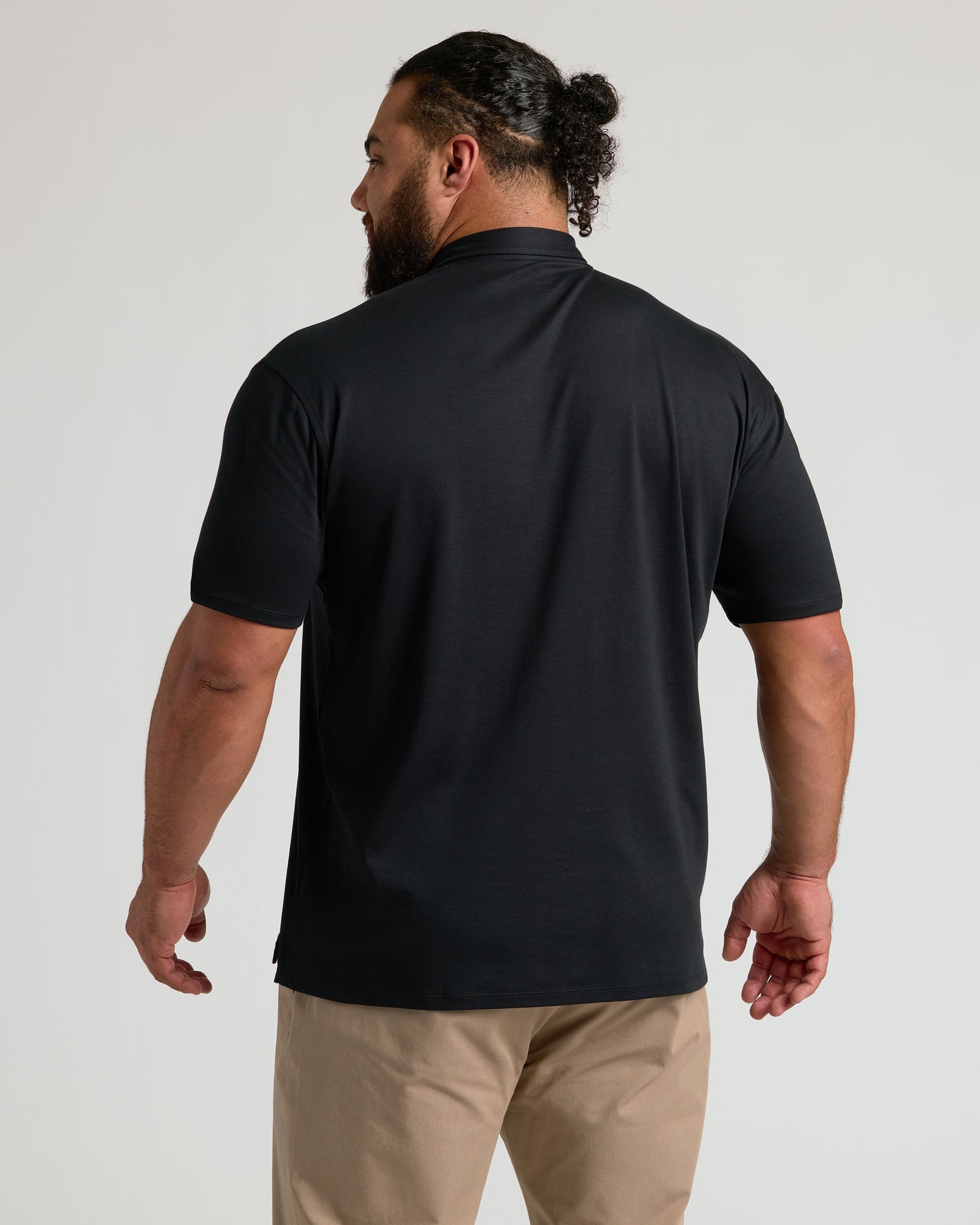 Black Premium Pima Polo 2-Pack worn by man, showcasing tailored fit.