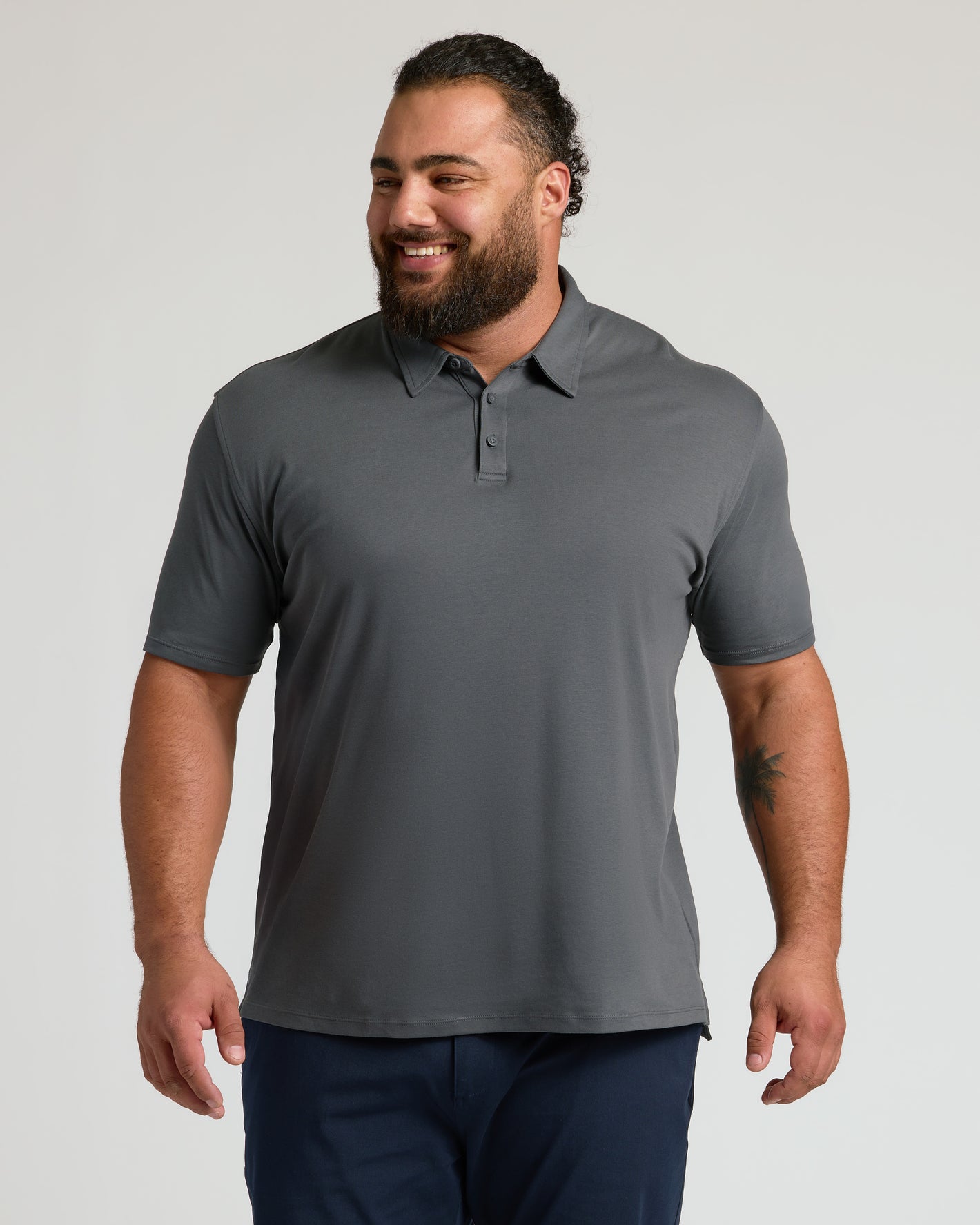 Man in Carbon Premium Pima Polo with tailored fit and three-button placket.