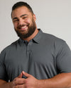 Smiling man wearing Premium Pima Polo, showcasing tailored fit.