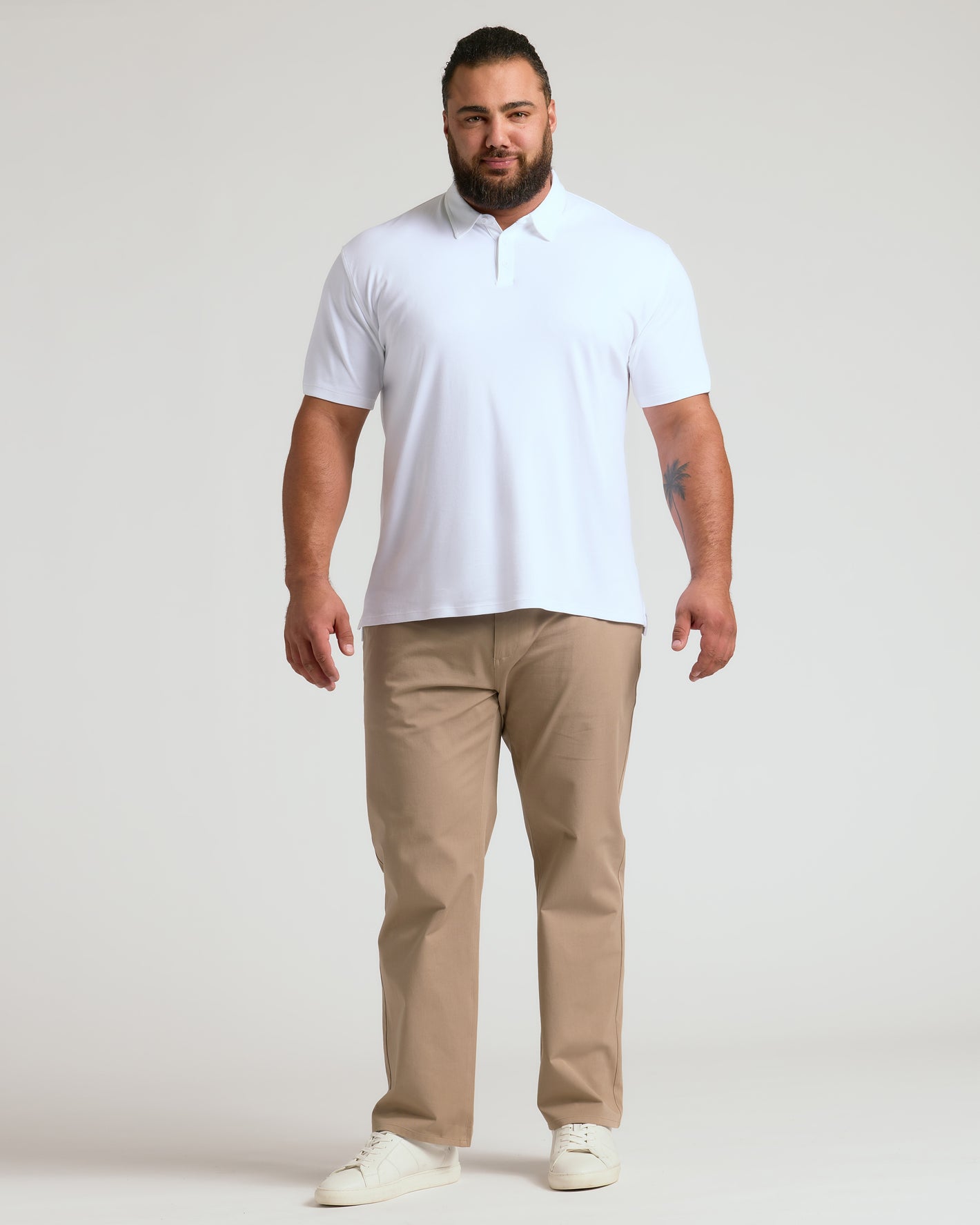 Man in White Premium Pima Polo, khaki pants, white sneakers.